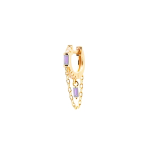 Detail of gold earrings with purple rectangular zircon and delicate chain tassels