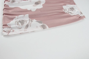 Detail of ruched floral fabric with rose print and silk-like satin texture on dress side