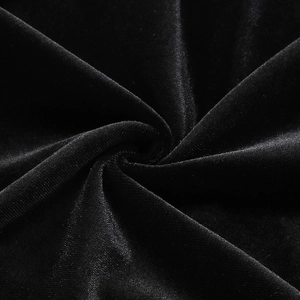 Detailed macro shot of premium black velvet fabric with elegant spiral draping