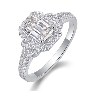 Macro view of emerald-cut moissanite stone and pavé setting on a 925 silver ring