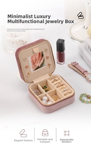 Pink velvet jewelry box detail showing mirror, ring slots and modular dividers