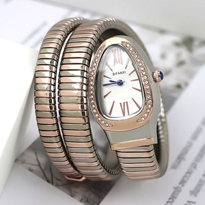 Macro view of serpent quartz watch featuring crystal bezel and rose gold teardrop dial