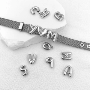 Silver mesh bracelet with customizable vintage alphabet charms and heart pendants