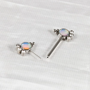 Detailed macro view of opal and zircon inlay on a silver stainless steel piercing stud