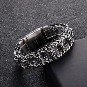 Close-up of 316L stainless steel clasp with engraved logo on vintage woven leather bracelet