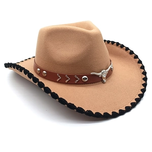 Detail of western cowboy hat with metal bull head ornament and woven brim edges