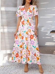 Detail of V-neck floral summer dress with elastic smocked waist and vibrant boho prints
