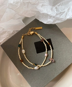 Close-up of double-layer beaded bracelet with freshwater pearls and gold-plated details