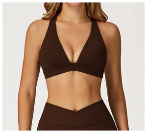 Detail of high-waisted yoga leggings with crossover V-shaped waist and matte finish fabric