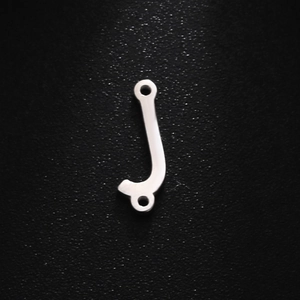 Macro detail of silver stainless steel J-shaped letter charm with double mounting holes