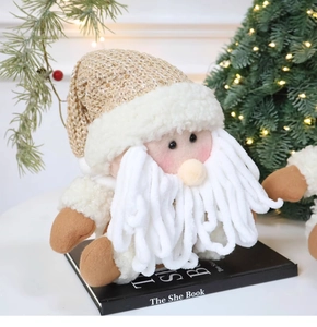 Close-up of Santa plush doll with sequined knit hat and soft beard on festive background