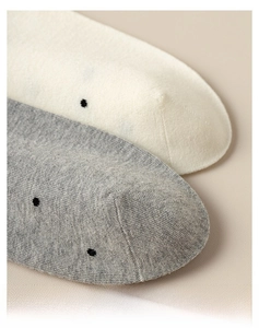 Detail view of seamless toe stitching on polka dot cotton socks for comfort