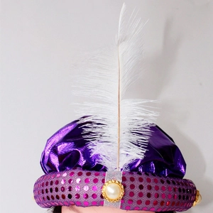 Close-up of purple satin Aladdin prince hat with white feather and sequin details