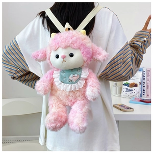 Cute pink plush pig backpack with green lace bib and beige straps shown on a model