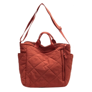 Quilted reddish brown tote bag with adjustable straps for versatile commuting style