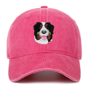 Close-up of pink washed cotton baseball cap featuring detailed Bernese Mountain Dog embroidery