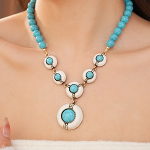 Macro view of vintage resin necklace with turquoise beads and golden crystal accents