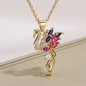 Golden flamingo pendant necklace with colorful marquise gemstones and a white pearl drop
