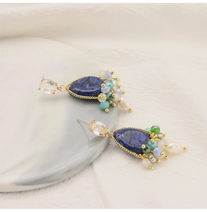 Detailed macro view of teardrop lapis lazuli earrings with colorful beaded accents