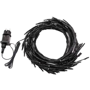 Macro view of solar rattan branch light string with black power adapter and cables