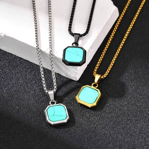 Detail of square turquoise stone pendants with steel chains in gold, silver, and black finishes