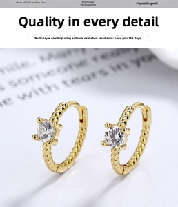 Macro shot of gold-plated S925 sterling silver rope earrings with shiny zircon stone
