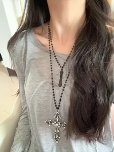 Detail of layered gothic cross necklaces with black beads and sparkling rhinestones
