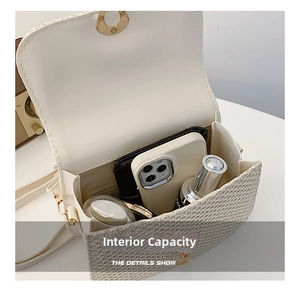 Internal capacity of woven crossbody bag showing phone, wallet, and cosmetics