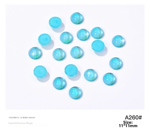 Macro shot of 11mm aurora blue round glass cabochons for nail art decoration