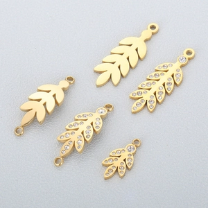 Detailed view of assorted golden leaf-shaped jewelry pendants with sparkling diamond accents