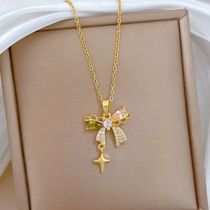 Close-up of golden butterfly and star necklace with vibrant multi-color zircon stones