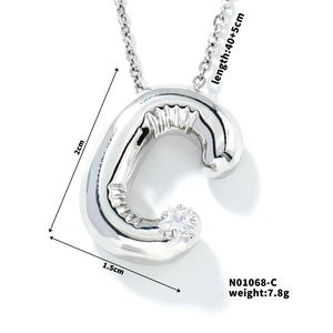 Macro detail of silver balloon letter C pendant with zircon inlay and product dimensions