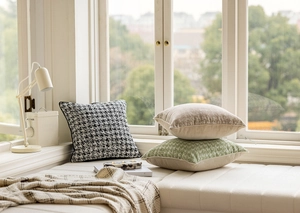 Detail of French beige luxury cushion covers with jacquard and houndstooth texture