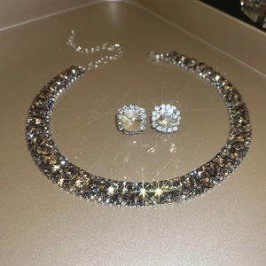 Sparkling grey rhinestone necklace and earrings set with brilliant starburst light effect