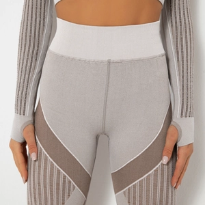Detail view of seamless striped yoga set with high waist leggings and thumbhole sleeves