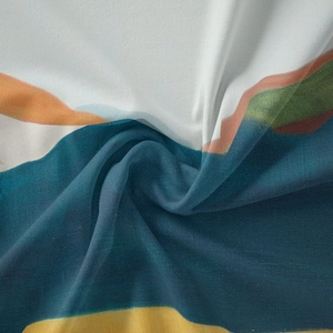 Close-up of abstract artistic print on lightweight bohemian fabric with silky texture