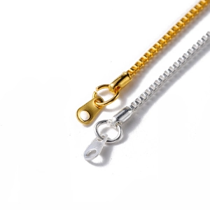 Macro detail of gold and silver box chains with jump rings for DIY jewelry making