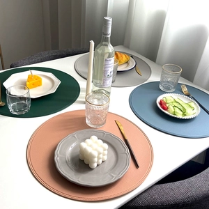 Set of round minimalist faux leather placemats in multiple colors for dining table decor