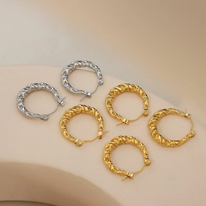 Minimalist twisted rope hoop earrings in gold and silver finish with geometric texture