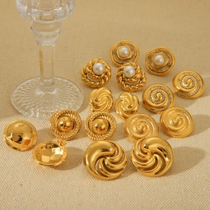 French vintage 18K gold plated spiral earrings with pearls on beige fabric backdrop