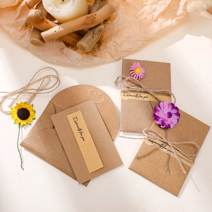 Handmade kraft paper greeting card with dried flowers and twine for special occasions