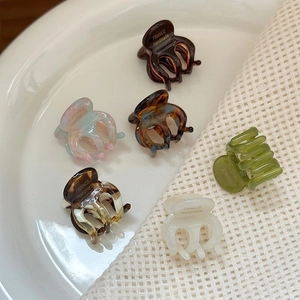 Mini acetate hair claws in various colors with France Handmade text on ceramic tray