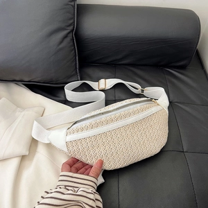 Fashionable woven straw fanny pack with white leather trim and adjustable canvas strap