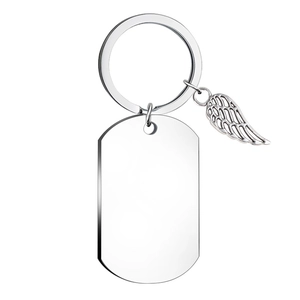 Detail of polished stainless steel keychain with angel wing charm and blank dog tag