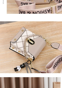 Détail du sac bandoulière matelassé beige avec bandoulière large et pendentif ours