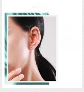 Close-up of minimalist S925 sterling silver four-point star stud earring with a small zircon