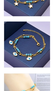 Detail of gold-plated layered anklet featuring turquoise beads and evil eye charm