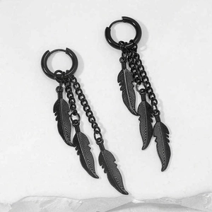 Detail shot of black stainless steel feather earrings with long hanging metal chains