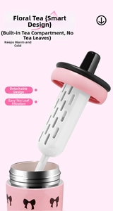 Pink stainless steel thermal cup featuring a removable tea infuser and bow decoration