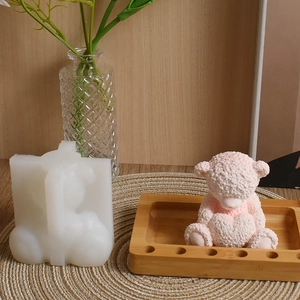 Detailed view of 3D bear silicone mold and pink finished candle with fuzzy texture